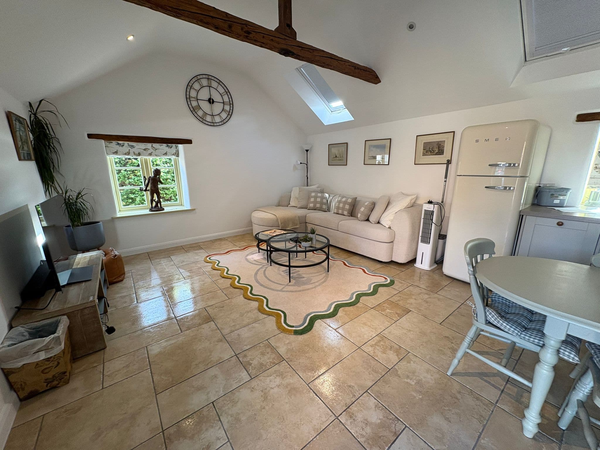 A cosy, beamed cottage living room, warm and tidy